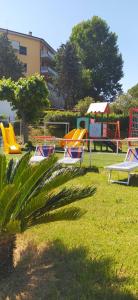 a group of lawn chairs and slides in a park at Villaggio Costa d'Argento in San Vito Chietino