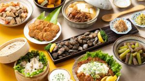 a table with many different dishes of food on it at Vessel Hotel Miyakonojo in Miyakonozyō