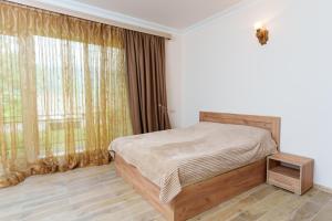 a bedroom with a bed and a large window at Avagyan's House in Ijevan