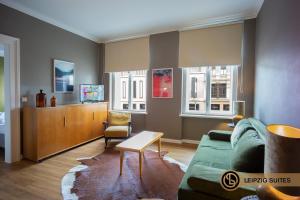 a living room with a couch and a chair at Marktblick Apartments nähe der RB-Arena in Leipzig