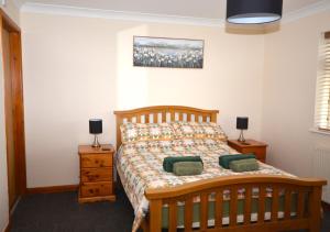 a bedroom with a wooden bed with two night stands at Rydon Ball in Abbotskerswell