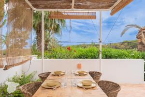 a dining room with a table with chairs and an umbrella at CostaBlancaDreams Casa Tres in Benissa Costa in Fanadix