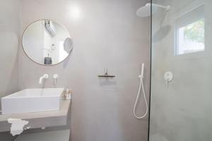 a white bathroom with a sink and a mirror at CostaBlancaDreams Casa Tres in Benissa Costa in Fanadix +10 photos