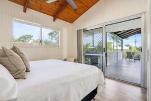 a bedroom with a bed and a balcony at Dunworkin Rainbow Beach in Rainbow Beach +21 photos