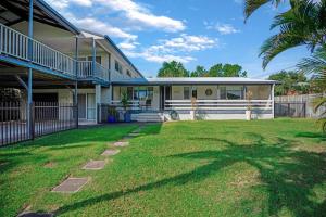 a house with a lawn in front of it at Dunworkin Rainbow Beach in Rainbow Beach