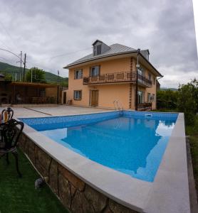 a house with a swimming pool in front of a house at Avagyan's House in Ijevan