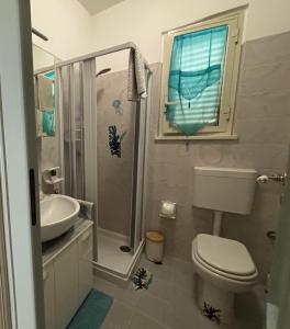 y baño con aseo, lavabo y ducha. en LA MANSARDA, en Giardini Naxos