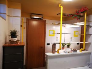 a bathroom with a toilet and a yellow pipe at 7 Panorama in Montecatini Terme