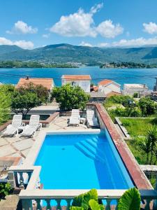 a swimming pool with a view of the water at INO Apartments in Tivat