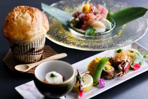 a table with two plates of food and a muffin at Dogo Onsen Yachiyo 道後温泉八千代 in Matsuyama
