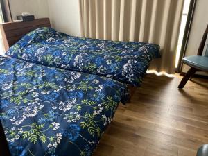 Postel nebo postele na pokoji v ubytování 貸別荘エスポワール浦