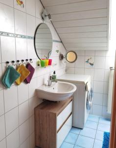 a bathroom with a sink and a washing machine at Drexl-Hof in Schwifting
