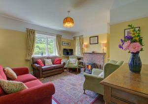 a living room with a couch and a fireplace at Bron y Fedw in Glyn-Ceiriog