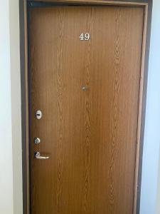 a wooden door with the number on it at Vezas Apartment 3beds in Klaipėda