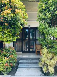 a house with glass doors and stairs in front of it at Akalanka Homestay in Gili Trawangan