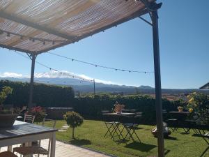 a view from a patio with a table and chairs at Good Morning Etna in Bronte