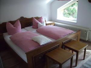 a bedroom with two beds with pink pillows and a window at Haus-Becker-Schmidt-St-Blasien in St. Blasien