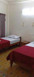a room with two beds in a room at Kodai Elegance in Kodaikānāl