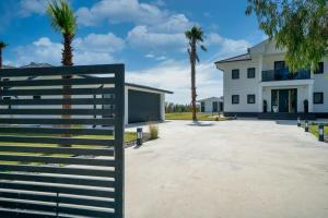 a house with a gate in front of a driveway at NEO Dalyan Residences - Villa 1 in Ortaca