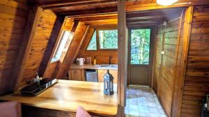 a kitchen with a wooden table in a cabin at VIVA SOLE domek nr 8 in Skorzęcin