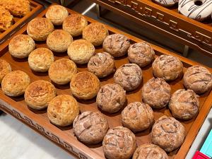 a tray filled with lots of different types of bread at Crowne Plaza Hangzhou Linping, an IHG Hotel in Hangzhou