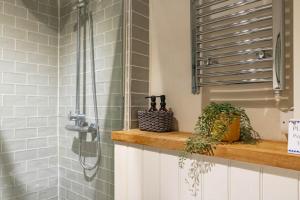 a shower stall in a bathroom with a sink at Host & Stay - The Old Post Office in Docking +21 photos