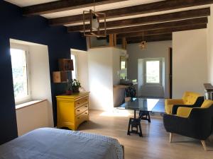 a bedroom with a bed and a desk in a room at Cambrassa in Vals-les-Bains