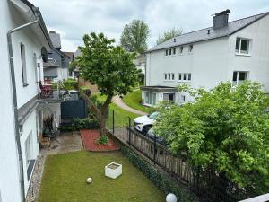 an apartment balcony with a yard with a car at Fewo Zentral in Willingen