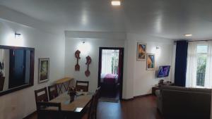 a living room with a table and a couch at Chanya Luxury Apartment, S 31, Lake View Residencies in Nuwara Eliya