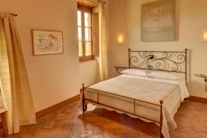 a bedroom with a white bed and white walls at Albergo San Lorenzo in Poppi