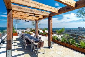 a patio with a table and chairs on a roof at Niche Living - Dun Laoghaire in Dublin