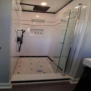 a shower with a glass door in a bathroom at Fun Fishtown Rowhome - Sleeps 4 in Philadelphia