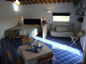1 dormitorio con cama, mesa y sofá en Podere Del Fagiano, en Tolentino