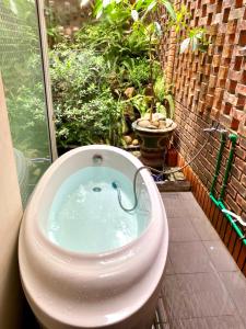 a toilet bowl with an elephant in it in a garden at Moon Homestay Huế in Thôn Dương Xuân Hạ