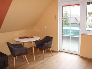 a room with a table and chairs and a window at Ferienwohnung-Sonnenterrasse in Malchow +21 photos