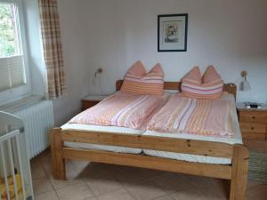 a bed with two pillows on it in a bedroom at Janssen in Norddeich
