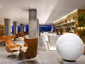 a hotel lobby with a white globe on the floor at Pullman Abidjan in Abidjan