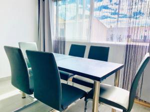 a table and chairs in a room with a window at Appartement Cap Estivales in Cap d'Agde +9 photos