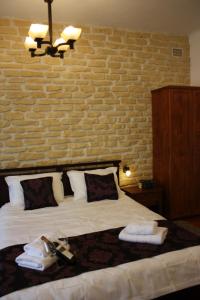 a bedroom with a bed with a brick wall at Casa Romana in Turda