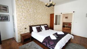 a bedroom with two beds and a brick wall at Casa Romana in Turda