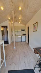 a large kitchen with wooden floors and a wooden ceiling at Tihase one bedroom garden view apartment in Tallinn