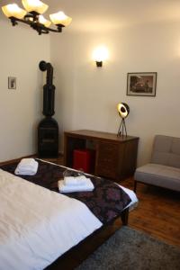 a bedroom with a bed and a stove and a couch at Casa Romana in Turda