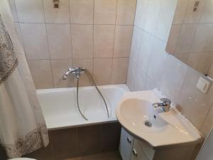a bathroom with a sink and a bath tub at Epanomi Apartments in Epanomi +27 photos
