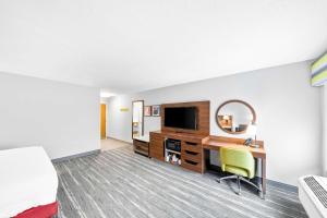a hotel room with a desk and a tv at Hampton Inn South Heritage Park in Lincoln