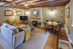 a living room with a couch and a table at Nook Cottage in Richmond