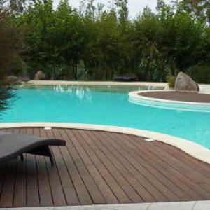 a swimming pool with a bench on a wooden deck at Quinta das Mineirinhas in Vila Nova de Cerveira
