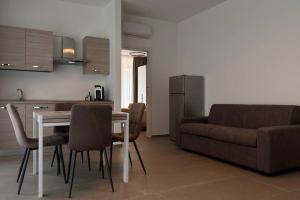 a kitchen and living room with a table and a couch at CconfortHotels Puglia Promenade Apartment 3 in Bari