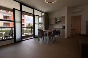 a kitchen and dining room with a table and chairs at CconfortHotels Puglia Promenade Apartment 3 in Bari