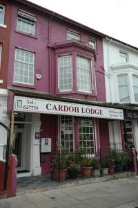 a purple building on a street with plants at Cardoh Lodge in Blackpool