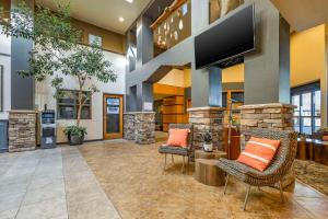 a lobby with two chairs and a flat screen tv at Hells Canyon Grand Hotel, Ascend Hotel Collection in Lewiston